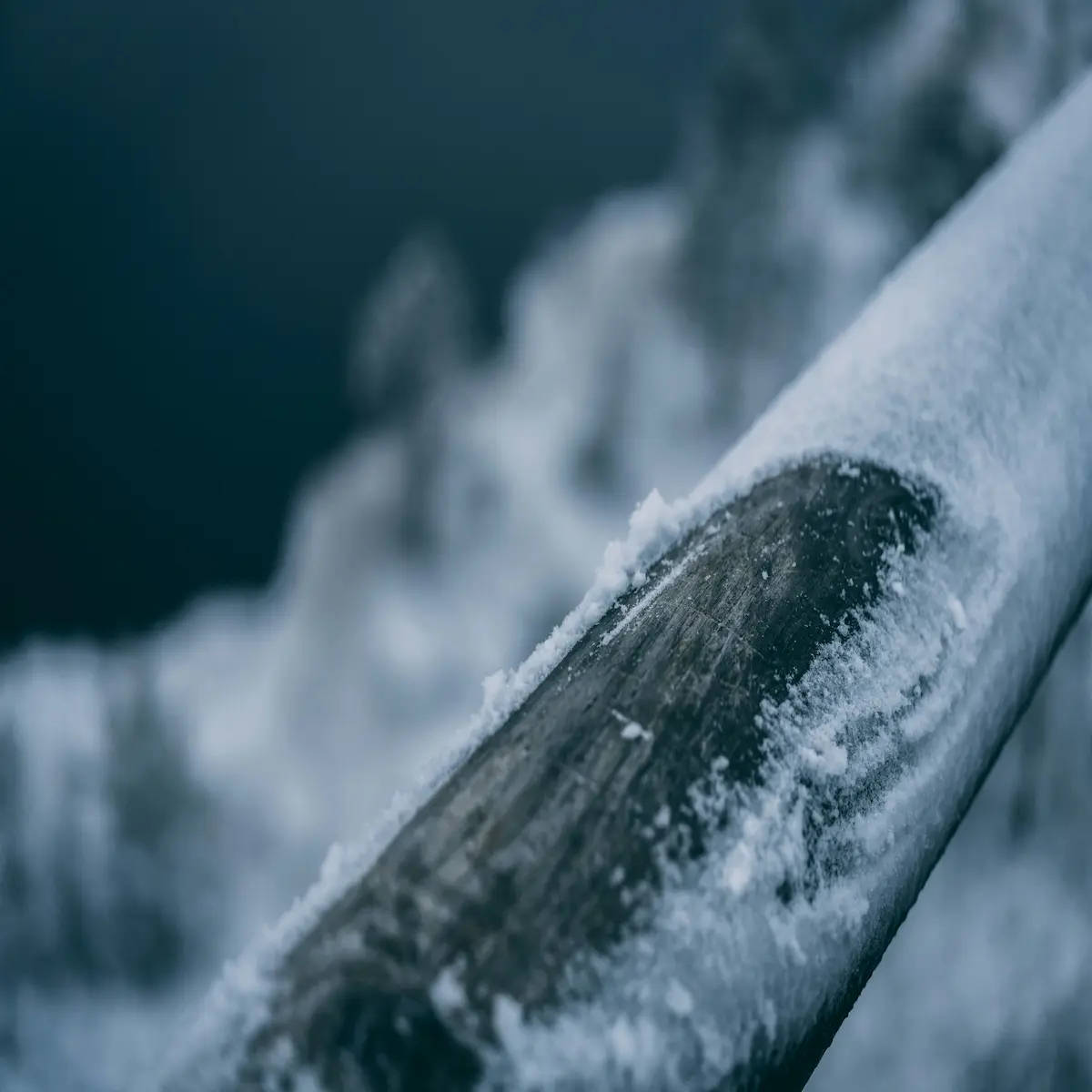 Frozen pipe covered in snow and ice during a hard freeze