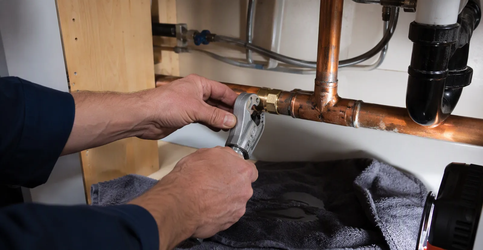 Repairing a burst copper pipe under a kitchen sink